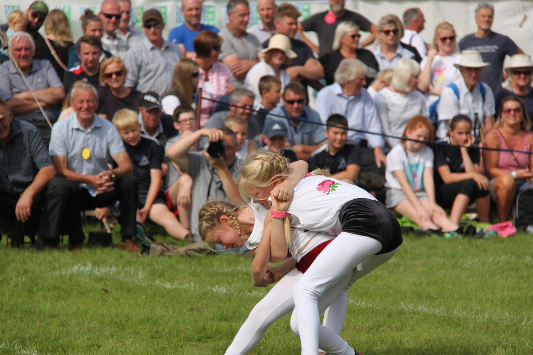 Young girls engaging in Cumberland & Westmorland Wrestling at Grasmere Lakeland Sports & Show 2022