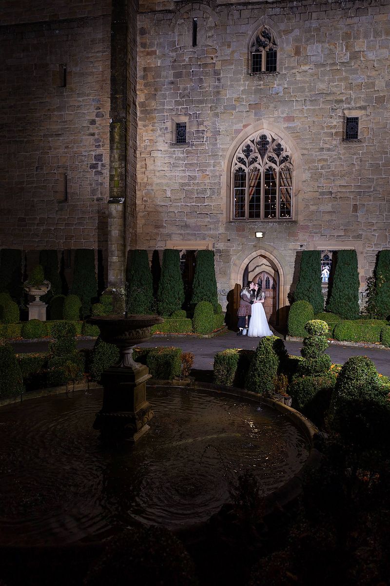 Wedding couple outside front door of Langley Castle, Northumberland