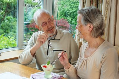 Couple sharing a vegetarian Sundae-type dessert 