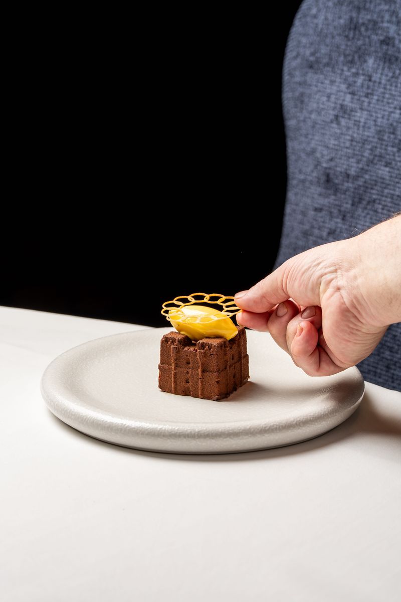 Finishing touches being applied to the Dark Chocolate Castle dessert, created as a replica of medieval Langley Castle Hotel, Northumberland, UK, in chocolate mousse.  The dish is the creation of Langley Castle's Culinary Director, Mark Greenaway.