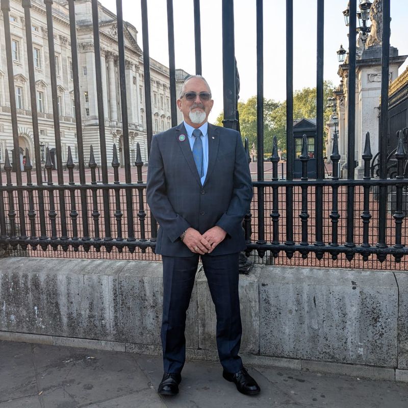 Bryan Baird outside of Buckingham Palace