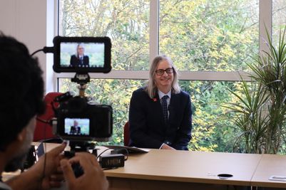 TEAM-Energy-head-of-operations-Tim-Holman-interviewed-visible-in-viewfinder-sat-in-front-of-a-window-with-greenery.JPG