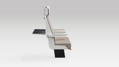 Side view of a pair of ALIZÉ rail seats with arms in normal position and tables open at the back.