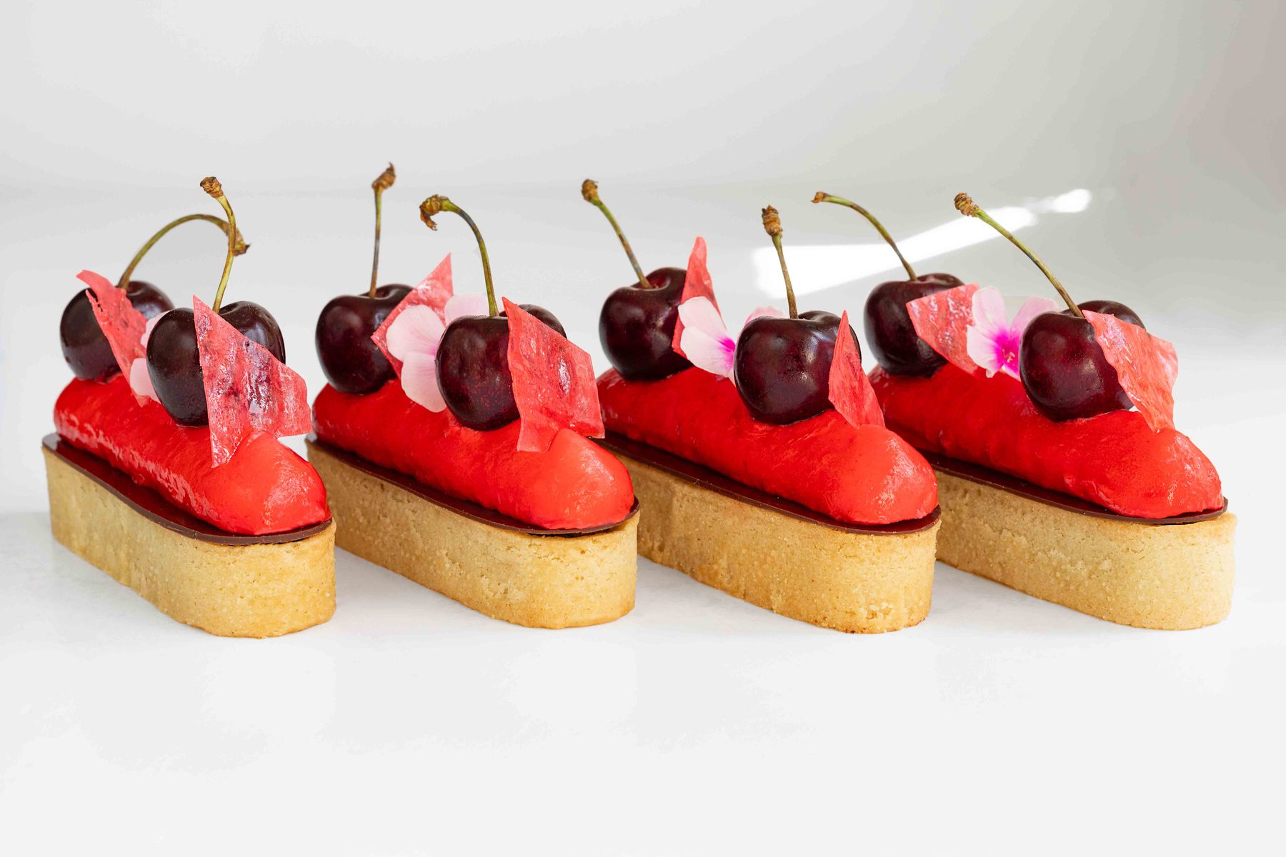Cherry on Top of the Cake, elegant poppy seeds and almond cream tartlet,  on top a light cherry cream.