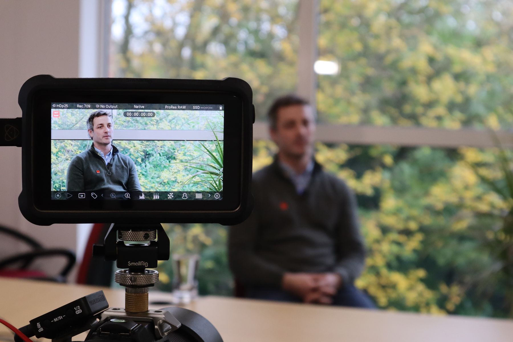 TEAM-Energy-Commercial-director-Tom-Anderton-interviewed-visible-in-viewfinder-sat-in-front-of-a-window-with-greenery.JPG