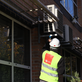 TEAM-Energy-consultant-Sam-Arje-checking-hvac-units.JPG
