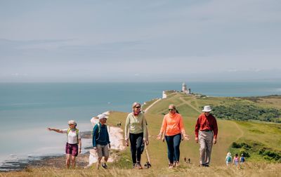 Ramblers walking on cliffs near Eastbourne, Sussex