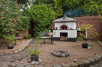 A Valoriani UK wood fired pizza oven installation in a garden