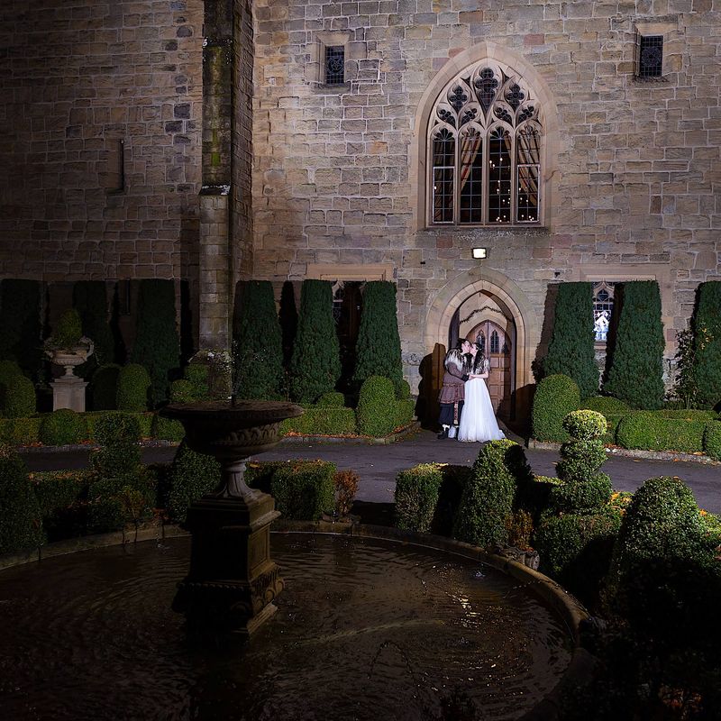 Wedding couple outside front door of Langley Castle, Northumberland