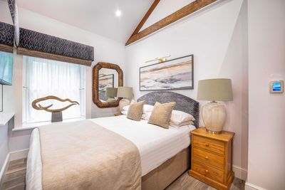 One of the bedrooms at Toll Bar Luxury Villa at Langley Castle, which comes with an en suite bathroom.