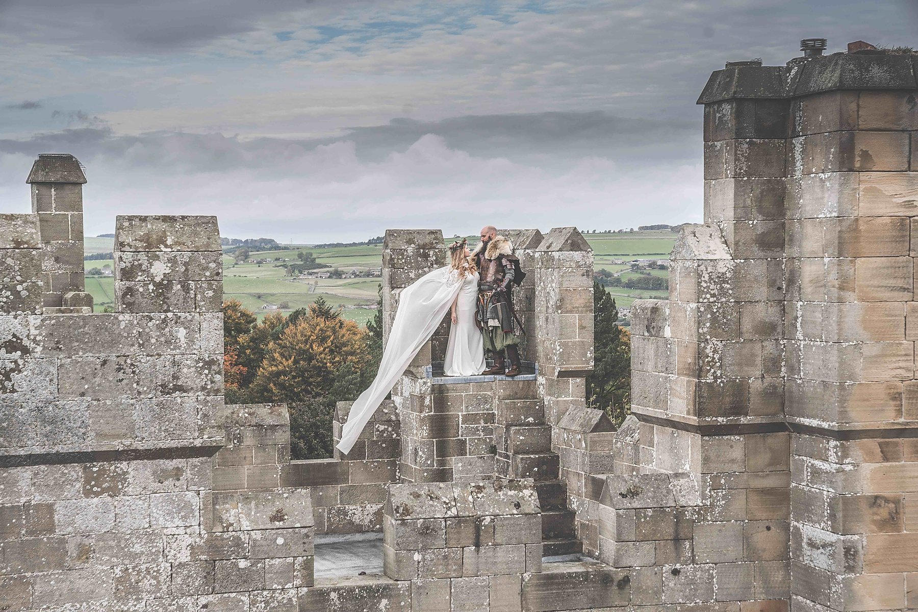 Couple on the battlements of Langley Castle Hotel, Northumberland, UK.