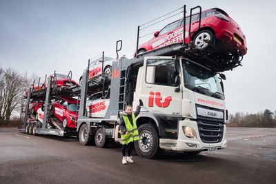 Young Driver pupil Bonnie (10) poses by lorry delivering first Suzuki Swifts