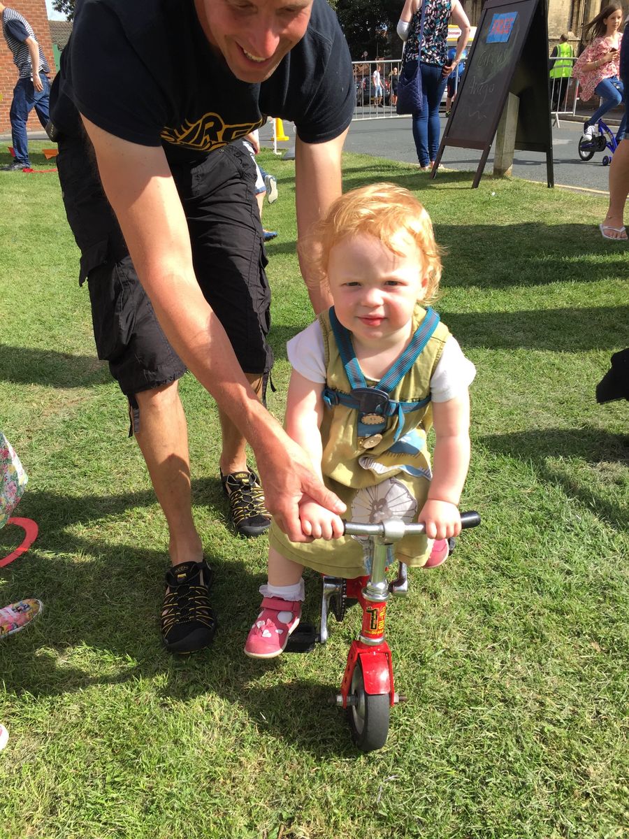 Toddler getting in on the Wonder Wheelers bicycle fun