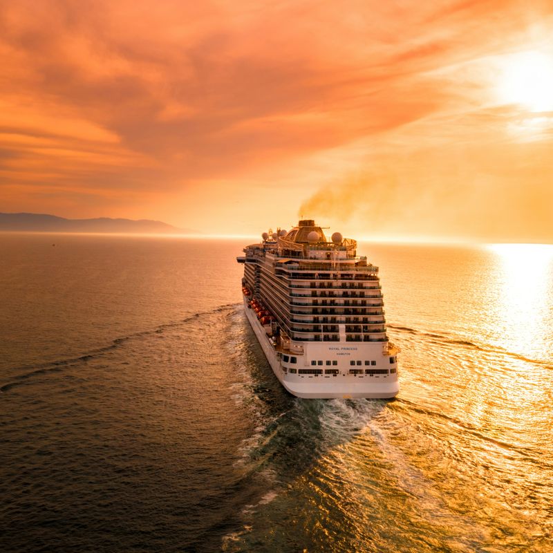 A cruise ship sailing into the sunset