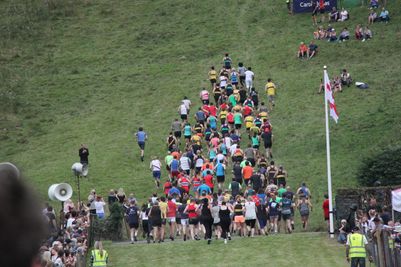 Runners heading up the fell at the start of a fell race at Grasmere Lakeland Sports and Show