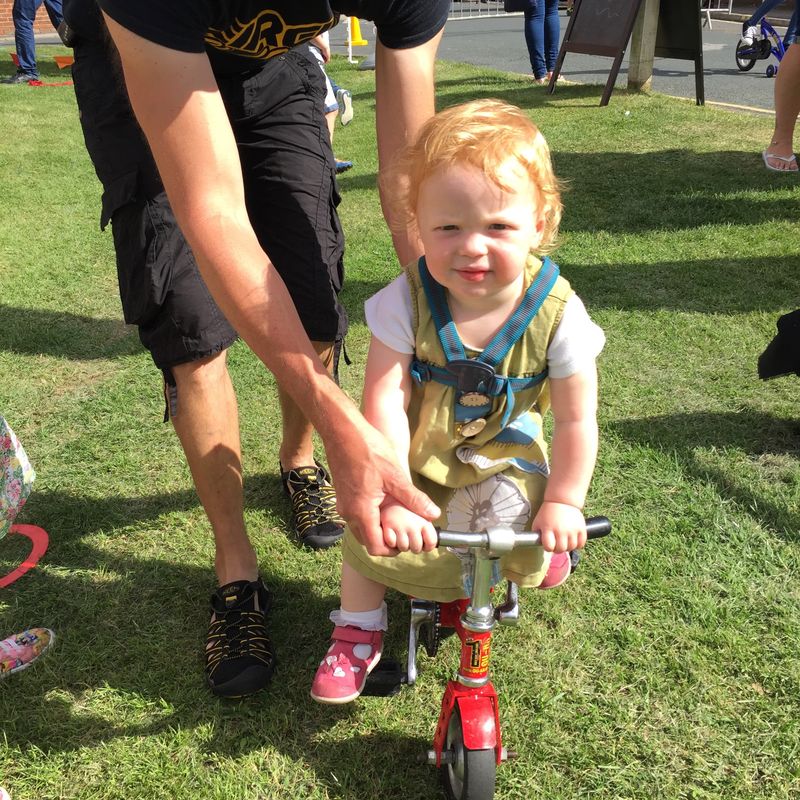Toddler getting in on the Wonder Wheelers bicycle fun