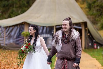 Benjamin and Annmarie Coomber, in front of the tipi at medieval Langley Castle, Northumberland, on the day of their Viking wedding