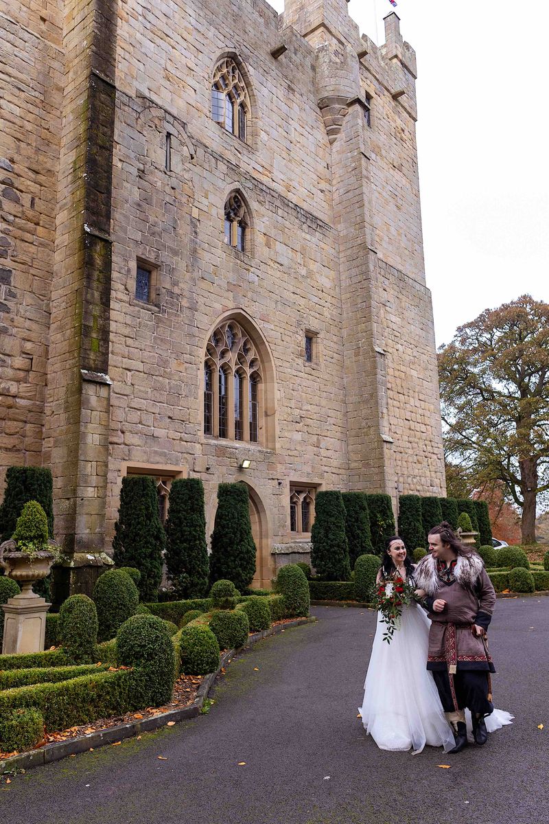 Benjamin and Annmarie Coomber in front of Langley Castle, Northumberland, on the day of their Viking wedding
