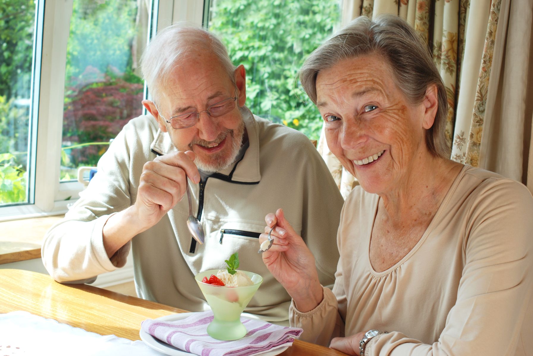 Vegetarian couple sharing a fruit dessert