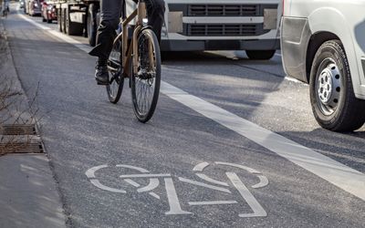 Cycle and lorry on busy route through an urban centre.
