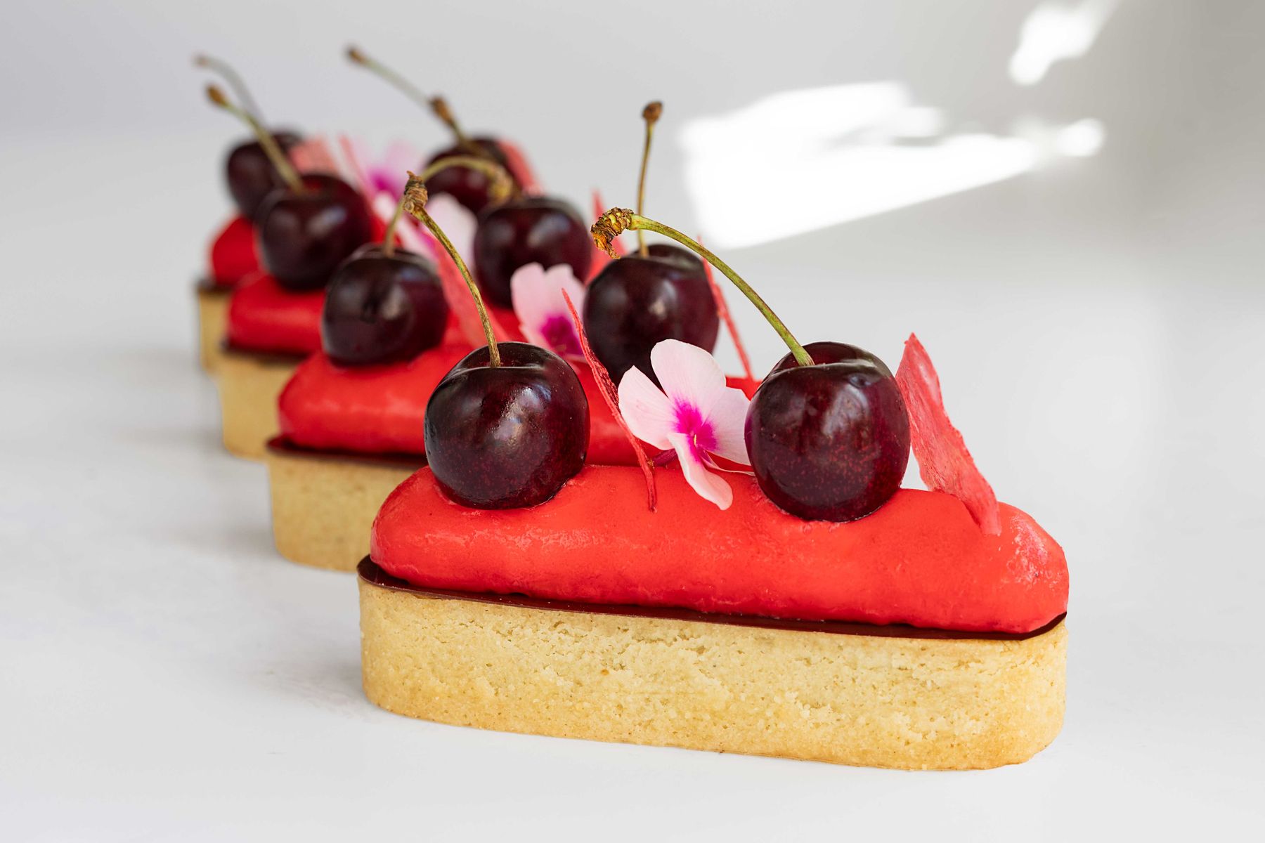 Cherry on Top of the Cake, elegant poppy seeds and almond cream tartlet,  on top a light cherry cream.
