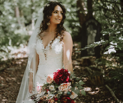 Couple Pippa-Rosy and Chris Parkes, marrying in the woodland wedding grove at Langley Castle, Northumberland, in July 2023.