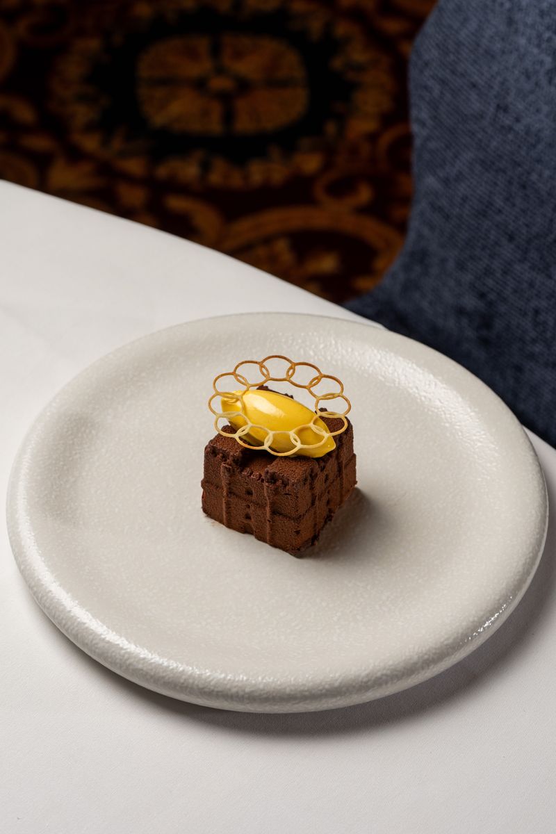 The complete Dark Chocolate Castle dessert, created as a replica of medieval Langley Castle Hotel, Northumberland, UK, in chocolate mousse.  The creation of Langley Castle's Culinary Director, Mark Greenaway.