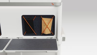 Close up of ALIZÉ pull-down table and holder for small personal belongings