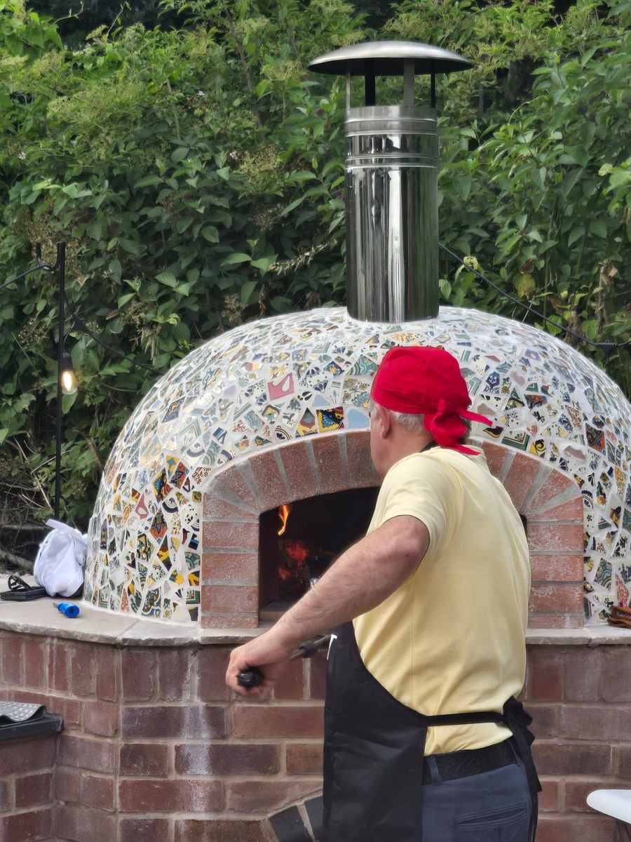 Andrew Manciocchi, owner of Orchard Ovens, cooking for guests at a customer's event, celebrating the 21st birthday of her son.
