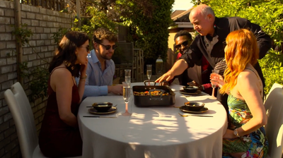Serving guests dining al fresco around a Valoriani wood-fired oven.