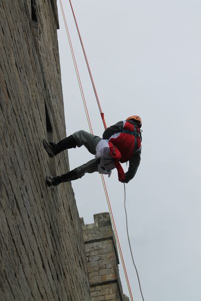 An intrepid knight clambers up  Langley Castle's walls 