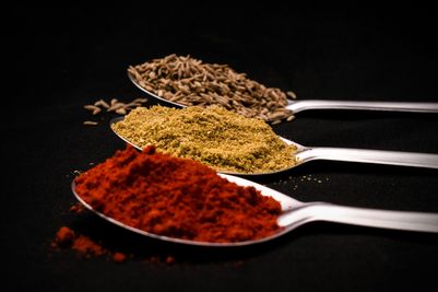 Array of spices on spoons, which could easily be used in dishes cooked in an Orchard Ovens-supplied Valoriani oven in the UK.