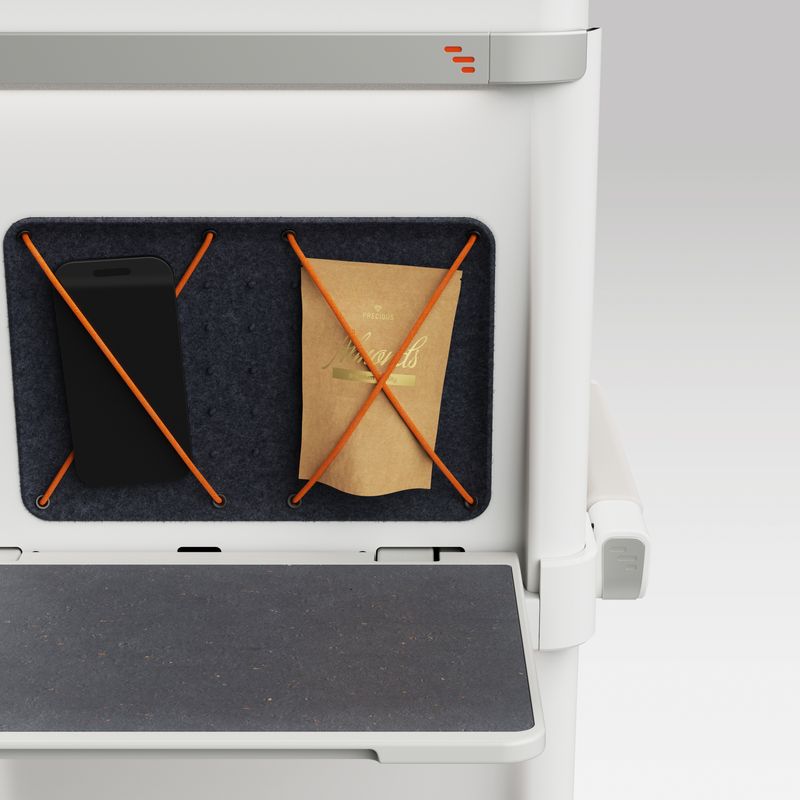 Close up of ALIZÉ pull-down table and holder for small personal belongings