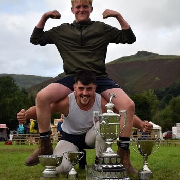 Thomas Gibson All Weights World Champion 2023 in Cumberland and Westmorland wrestling, in a contest won at Grasmere Lakeland Sports and Show, lifts one of the new 'names' in the sport, George Peacock.