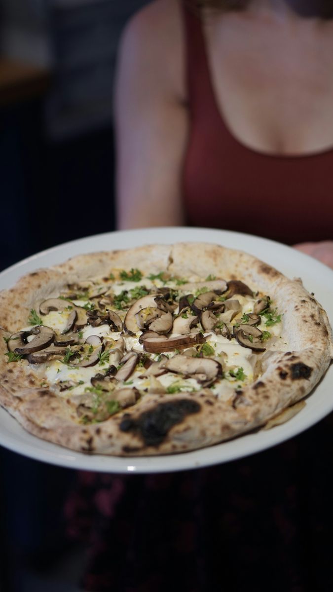 A burrata and mushroom woodfired pizza, using the creaminess of burrata cheese.