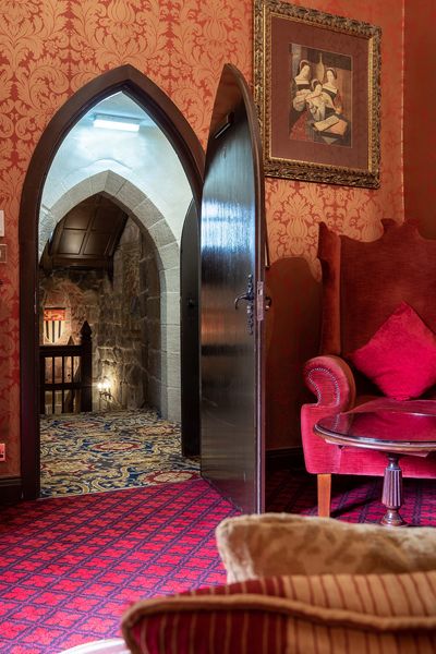 Looking towards the garderobes through a bedroom door at Langley Castle Hotel, Northumberland, UK