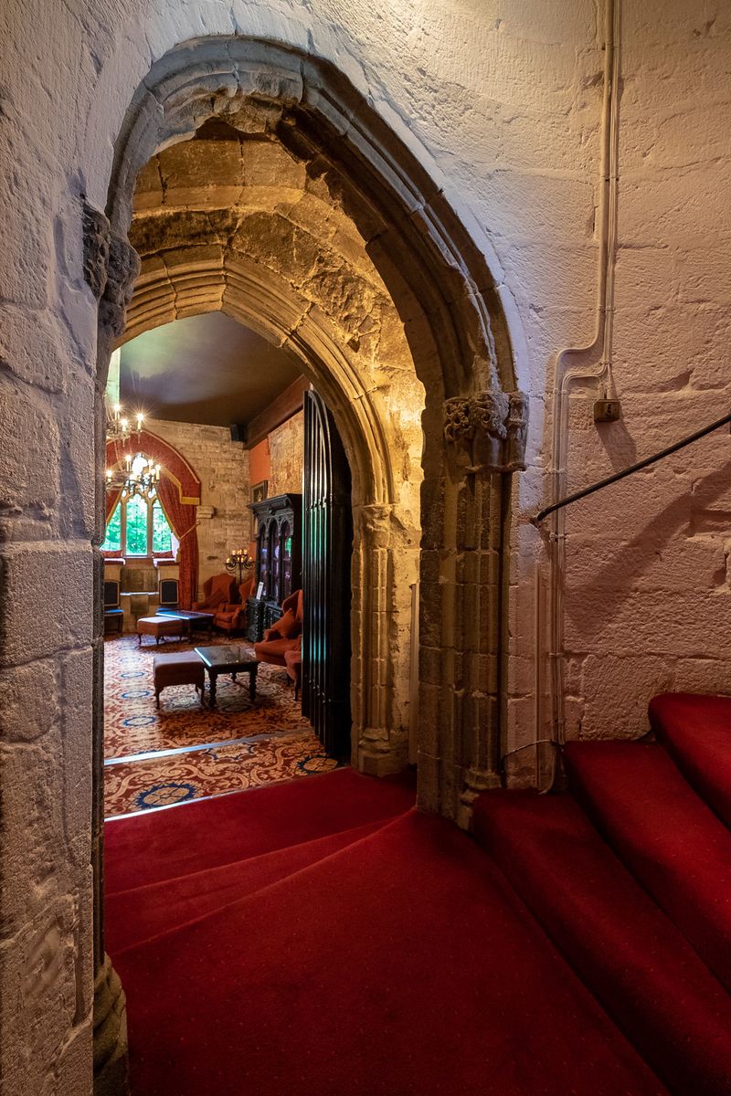 Looking through archways into the Drawing Room at Langley Castle Hotel, Northumberland, UK