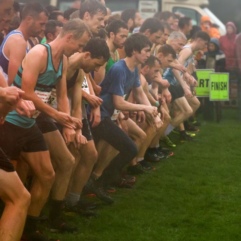 Fell racers on the start line at Grasmere Sports 2024, in soggy and wet conditions.