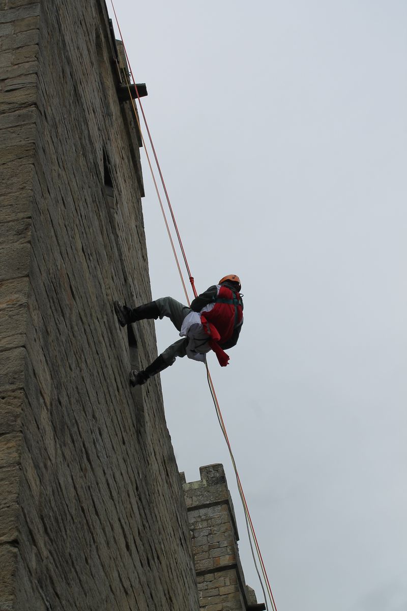 An intrepid knight clambers up  Langley Castle's walls 