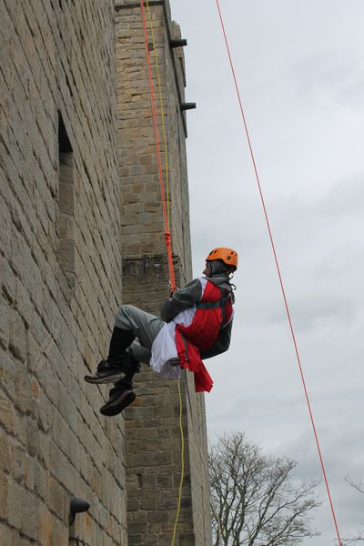 An intrepid knight clambers up  Langley Castle's walls 