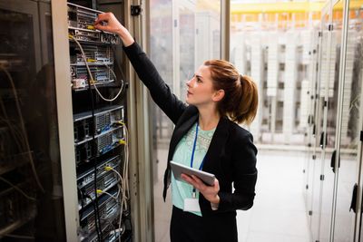 technician-holding-digital-tablet-while-examining-server.jpg