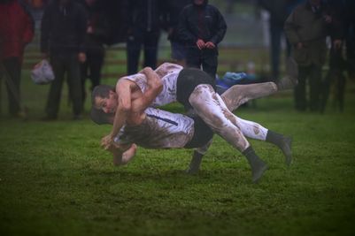 Cumberland and Westmorland wrestlers tackle the muddy conditions at the Grasmere Lakeland Sports and Show 2024.