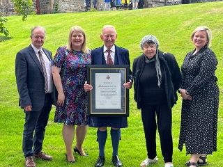 John Burns MBE receiving Honorary Fellowship for oustanding service to the community at the University of Wales Trinity St David.jpg