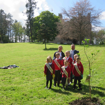 Pupils and teacher, with Langley Castle General Manager, Mohamed Serag, at the tree planting location below Langley Castle Hotel.