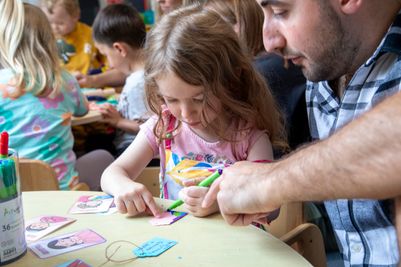 Children and parents taking drawing their thoughts for the kindness tree.jpg