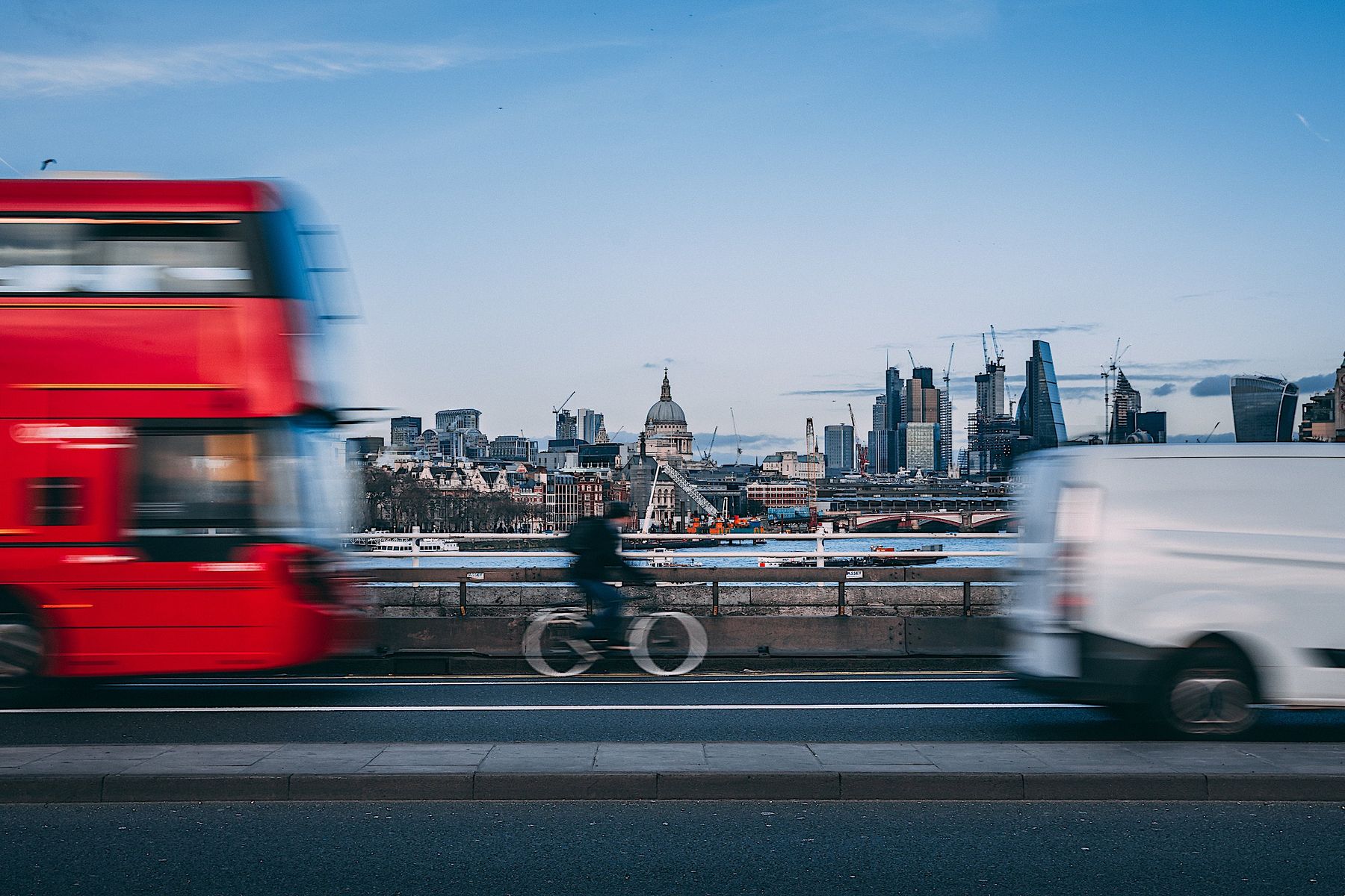 Bus and van sharing the road with a cyclist in London