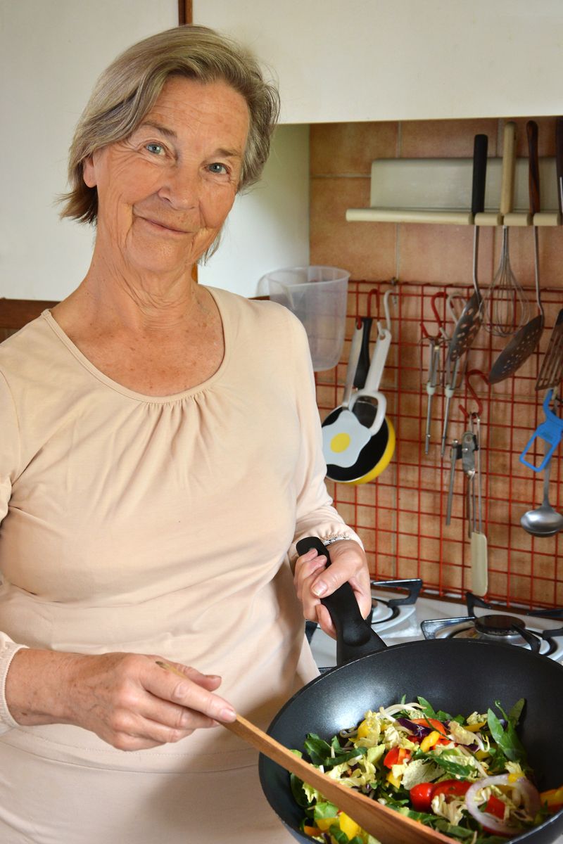 Lady cooking vegetarian stir fry