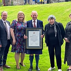John Burns MBE receiving Honorary Fellowship for oustanding service to the community at the University of Wales Trinity St David.jpg