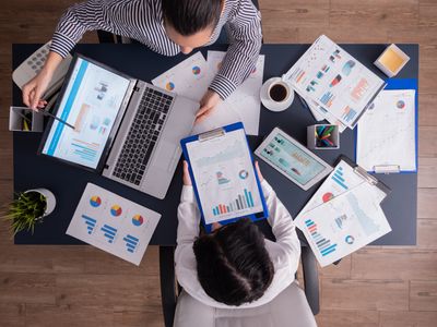 top-viewtop-view-manager-employee-doing-teamwork-business-office-looking-charts-laptop-display.jpg