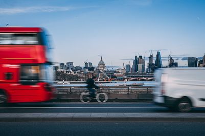 Bus and van sharing the road with a cyclist in London